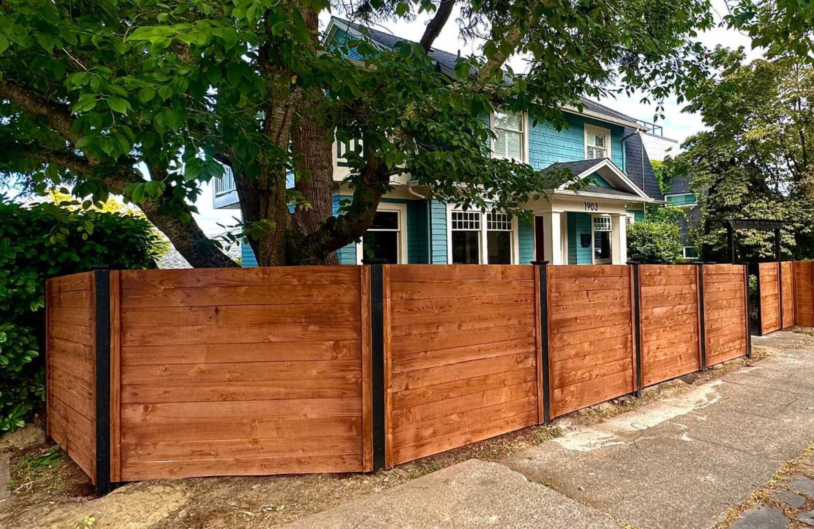 Beautiful horizontal wood fence with black posts in Lancaster, TX